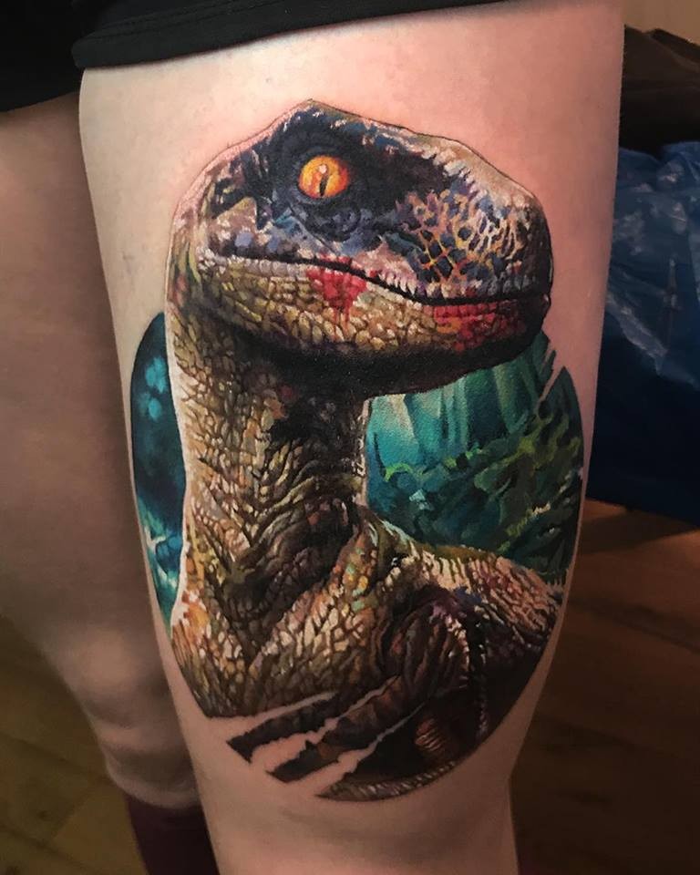 Great colorful dinosaur tattoo on thight