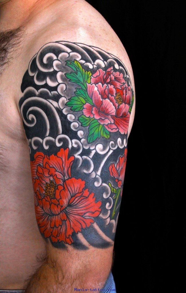 Great colorful japanise flowers on black background tattoo on upper arm