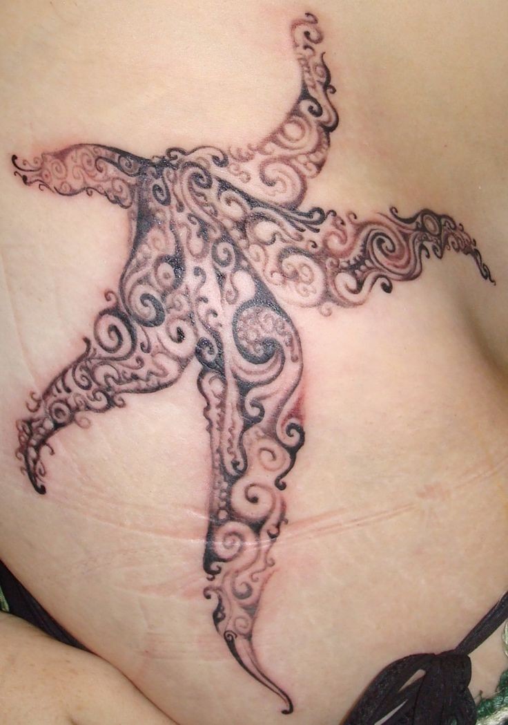 Great curled black-and-white starfish tattoo on side
