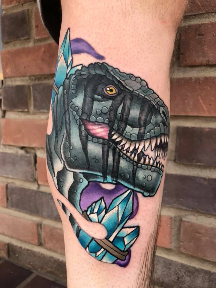 Great dinosaur head and crystals tattoo on leg