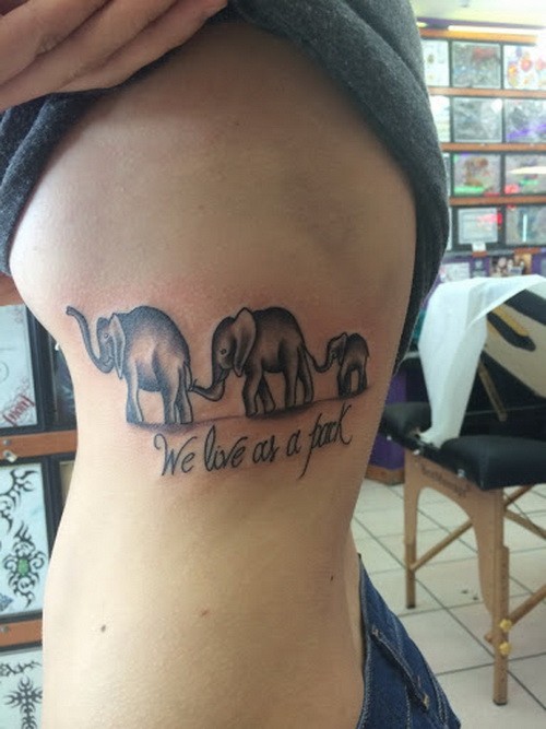 Great elephant family with lettering tattoo on rib-side