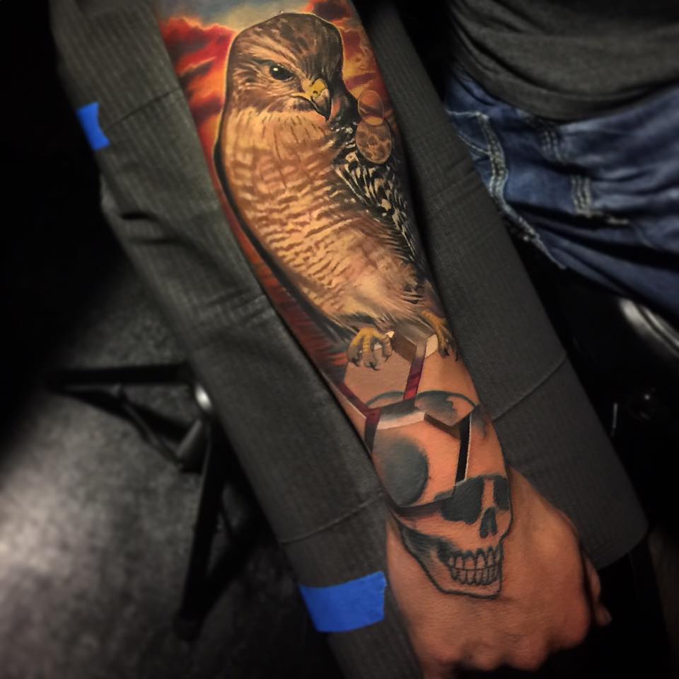 Great falcon and skull tattoo on forearm