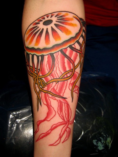 Great girly orange and red jellyfish tattoo on arm