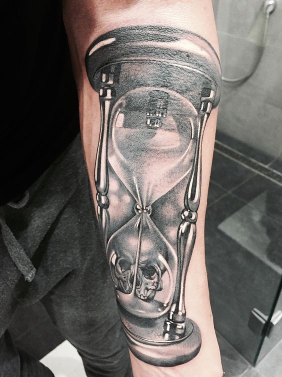 Great hourglass with skull forearm tattoo