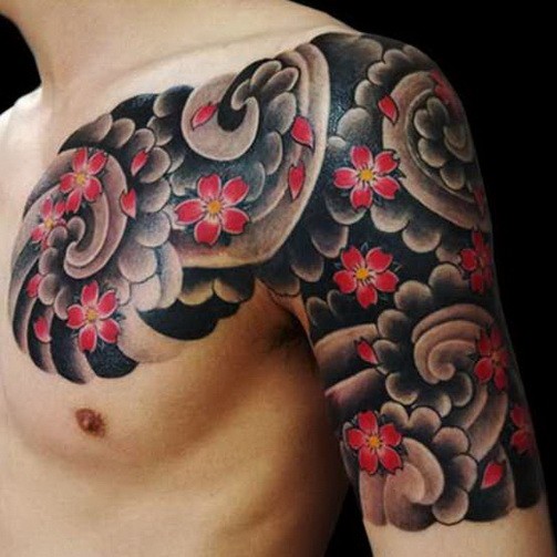 Great japanese flowers in black clouds tattoo on shoulder and chest