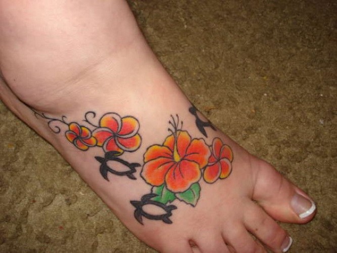 Great orange hawaiian flowers tattoo on foot