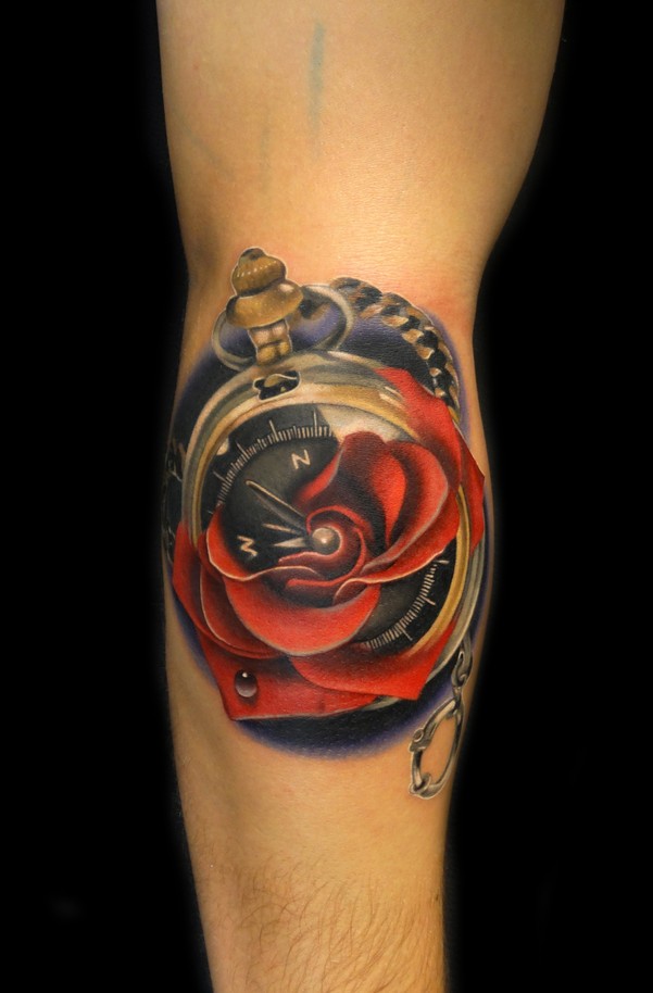 Great red rose and compas tattoo on arm