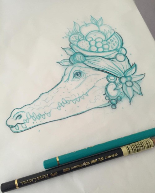 Green-ink female reptile heat with fruit on top tattoo design