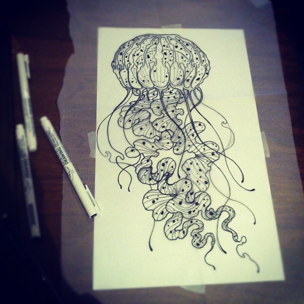 Grey-ink spotted jellyfish with big frilled tentacles tattoo design