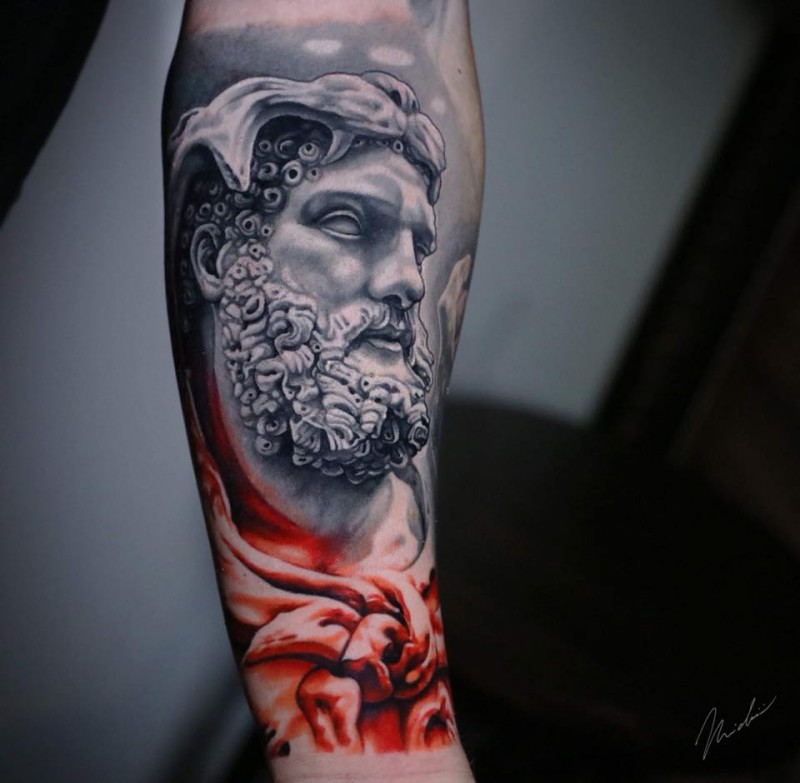 Hercules statue face tattoo on forearm