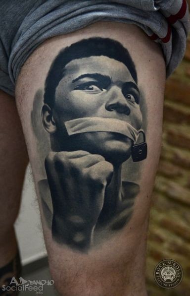 Horror like black and white thigh tattoo of man face with locked mouth