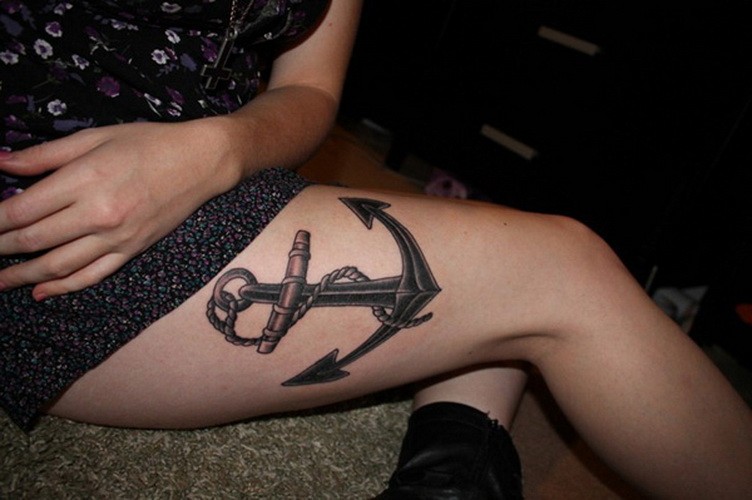 Huge black anchor tattoo on thigh