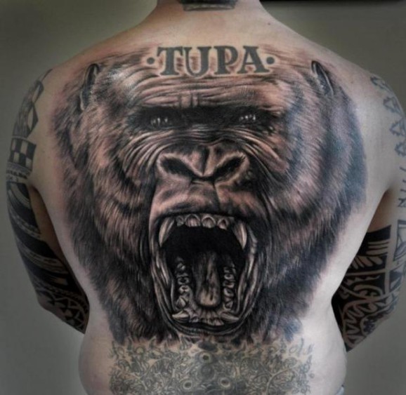 Huge realistic black-and-white gorilla tattoo on back