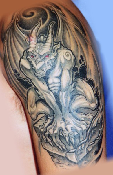 Illustrative style colored arm tattoo of gargoyle statue with red eyes