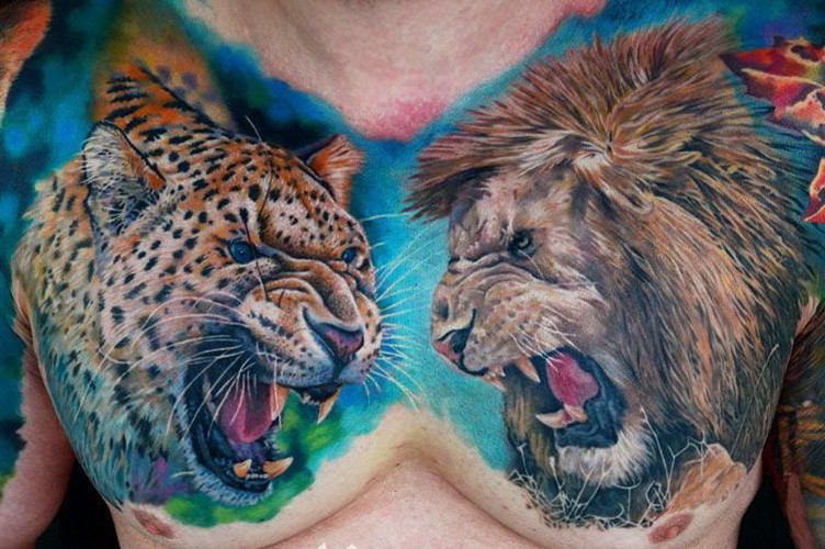 Impressive cheetah vs lion tattoo on full chest