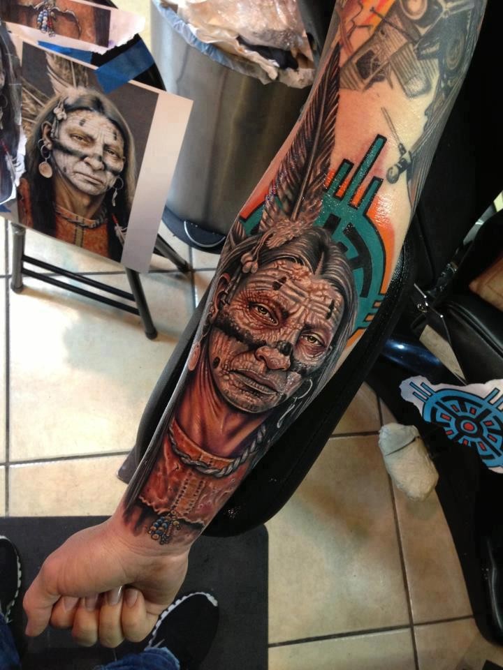 Indian head with war paint tattoo on forearm