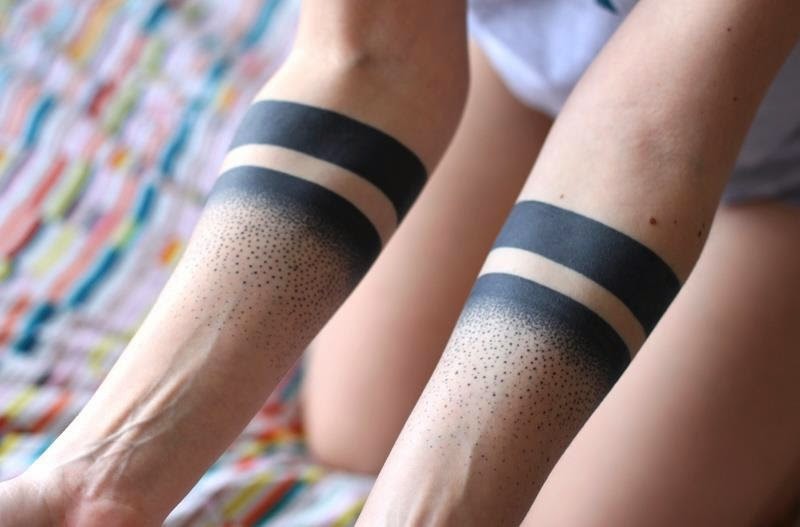 Interesting-designed double bands with spots tattoo on forearm