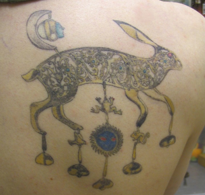 Interesting-designed hare with hanging elements tattoo on back