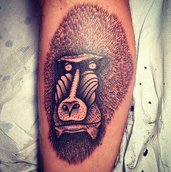 Interesting black-and-white baboon head tattoo on arm