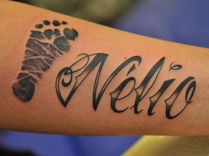 Interesting black name quote with foot print tattoo on arm