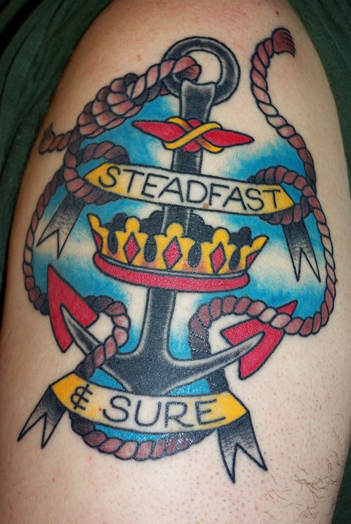 Interesting colored old school anchor with crown and signed ribbons tattoo on shoulder