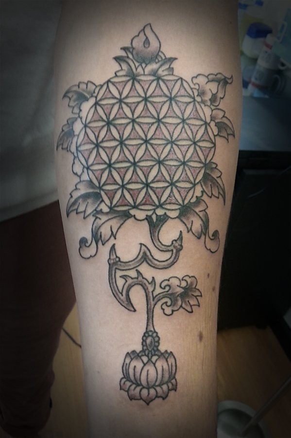 Interesting designed flower of life on stem growing from lotus tattoo on arm