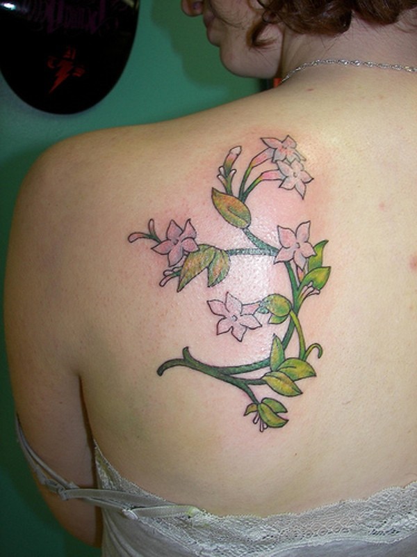Interesting designed jasmine flower tattoo on back