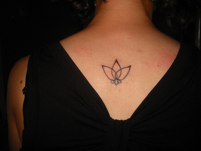 Interesting simple black-contour lotus flower tattoo on back