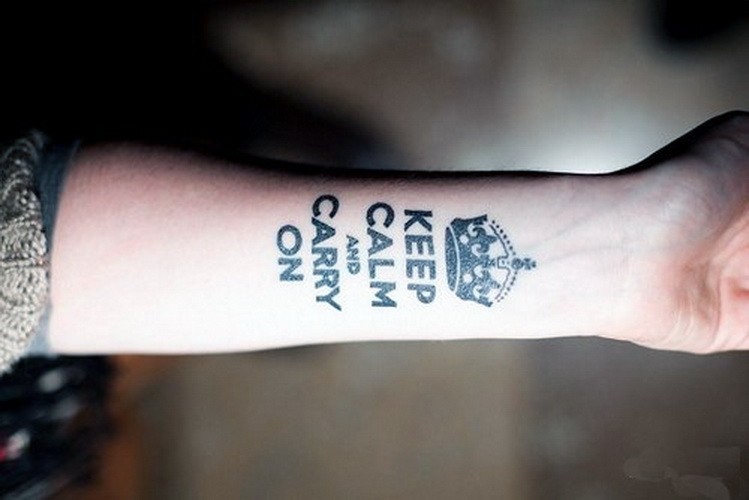 Keep calm and carry on quote with crown tattoo on arm
