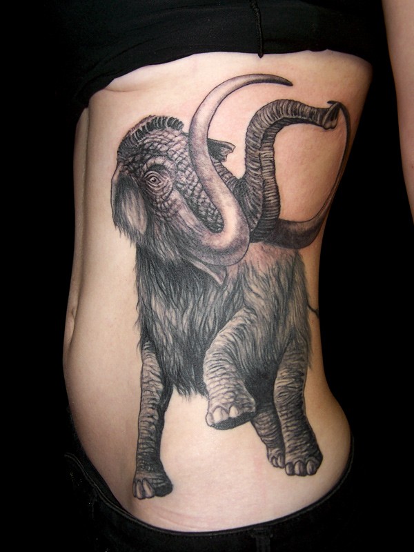 Large black-ink mammoth tattoo on side