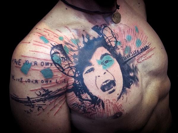 Large chest and shoulder tattoo of trash polka portrait and lettering
