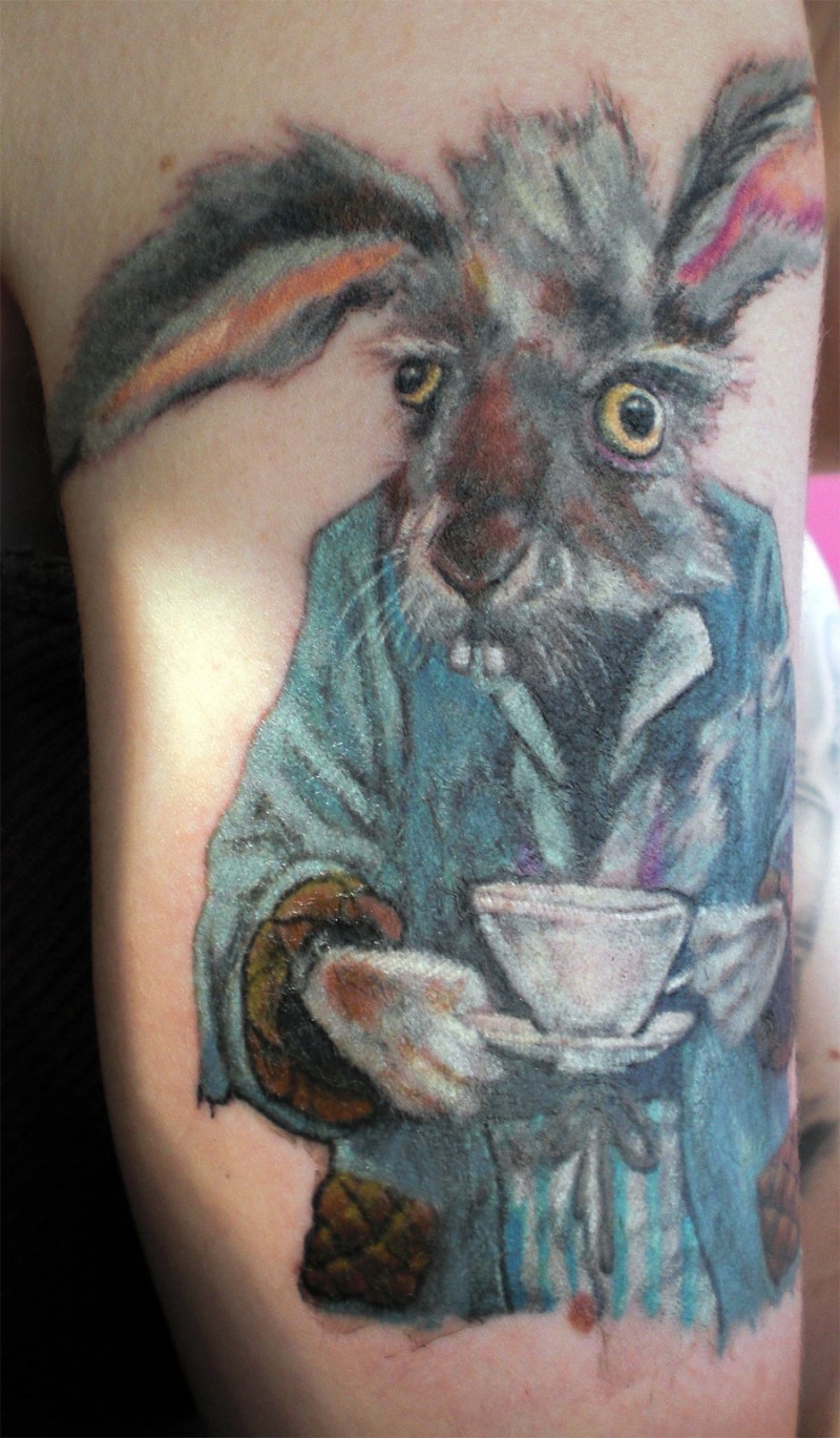 Large color-ink March hare tattoo on upper arm
