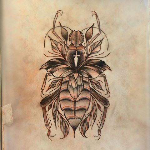 Light brown bug with leaf decorations tattoo design