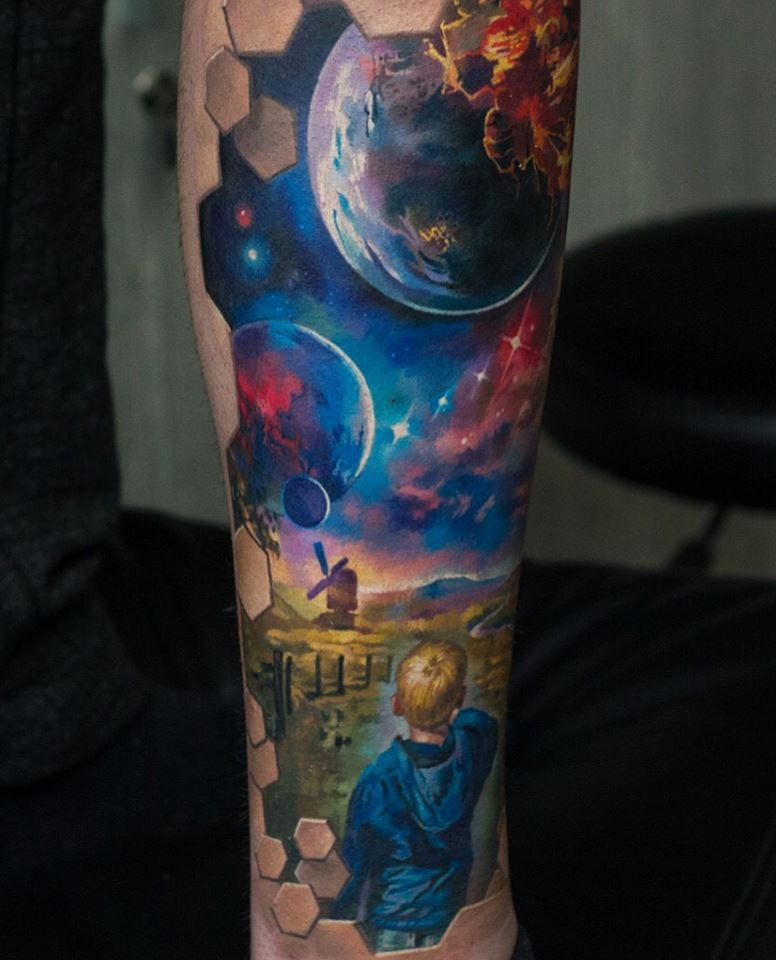 Little boy and space tattoo on forearm