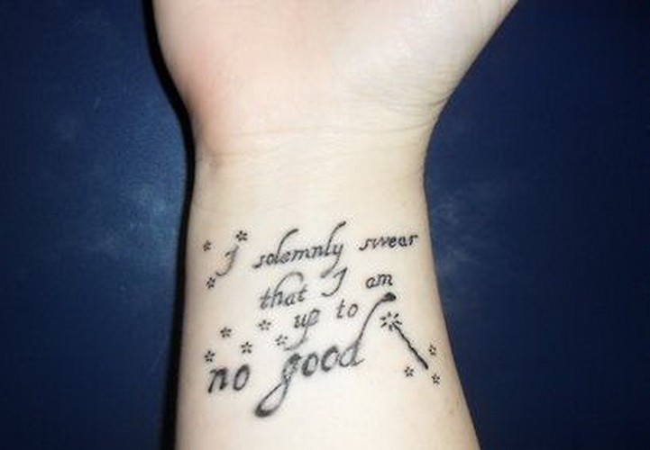 Little charming black-lettered quote tattoo on arm
