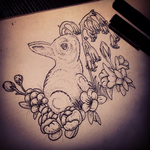 Little grey-ink rabbit sitting on flowered lawn tattoo design