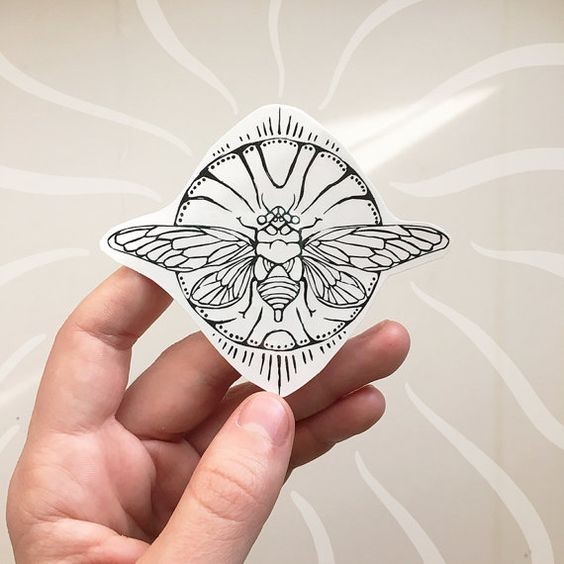 Little outline flying bug on circuled background tattoo design