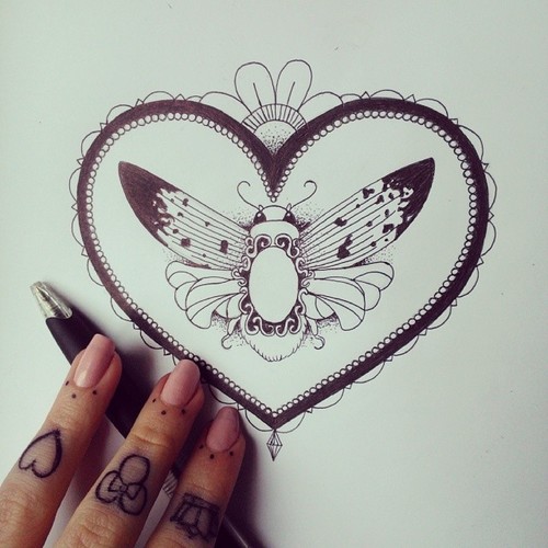 Lovely butterfly with gem decoration in heart frame tattoo design
