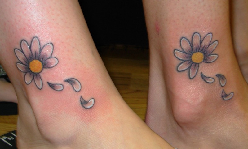 Lovely double daisy flower tattoos on feet