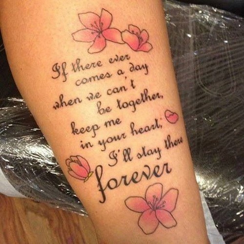 Lovely quote tattoo with pink flowers on arm
