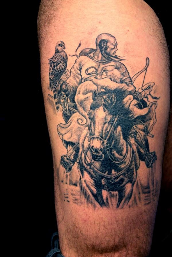 Mongolian warrior on horseback with a bird tattoo on thigh