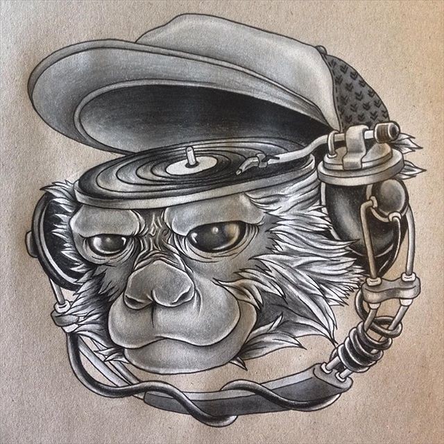 Monkey head with playing music plate tattoo design