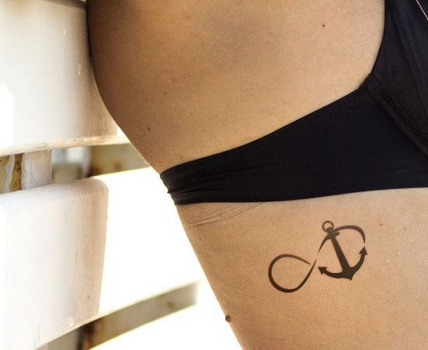Neat black female infinity anchor tattoo on rib-side