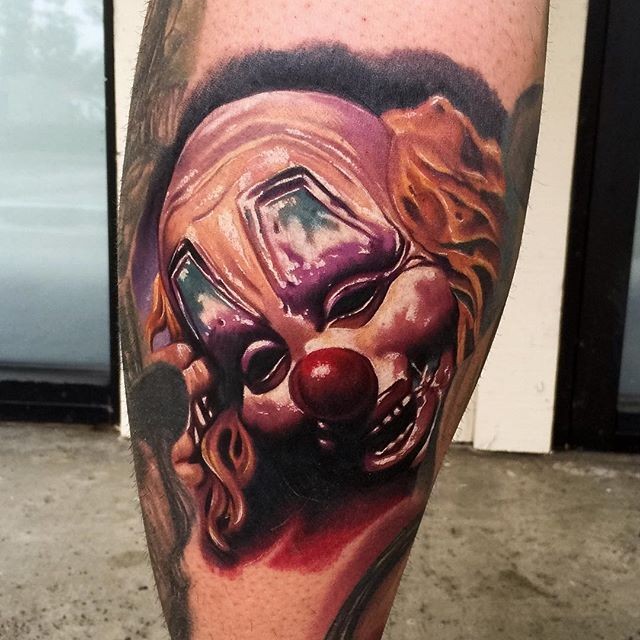 Neo traditional style colored leg tattoo of creepy clown