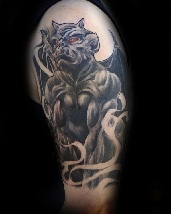 New school style colored upper arm tattoo of gargoyle statue with red eyes