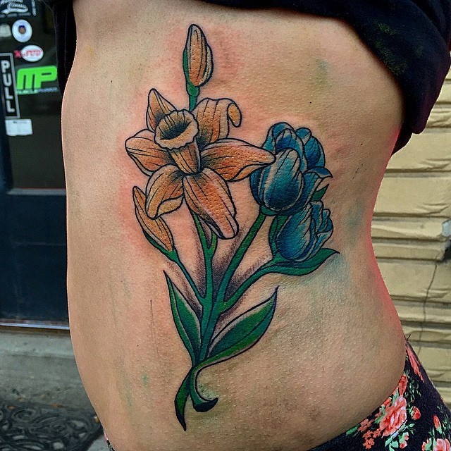 Nice yellow and blue american classic tattoo flowers on waist