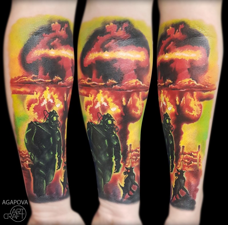 Nuclear explotions with man and dog tattoo on forearm