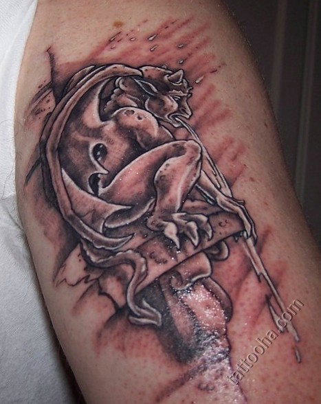 Old looking colored upper arm tattoo of old gargoyle statue