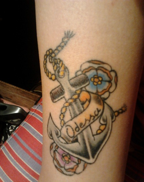 Old school flowered anchor with Odessa lettering tattoo on forearm