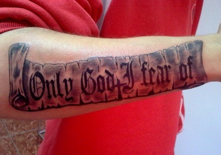 Only God I fear of quote on scroll tattoo on arm